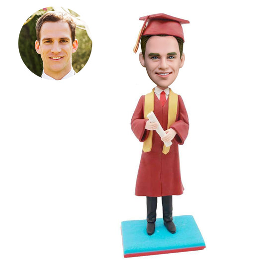 custom happy male graduation bobbleheads in red gown and yellow ribbon